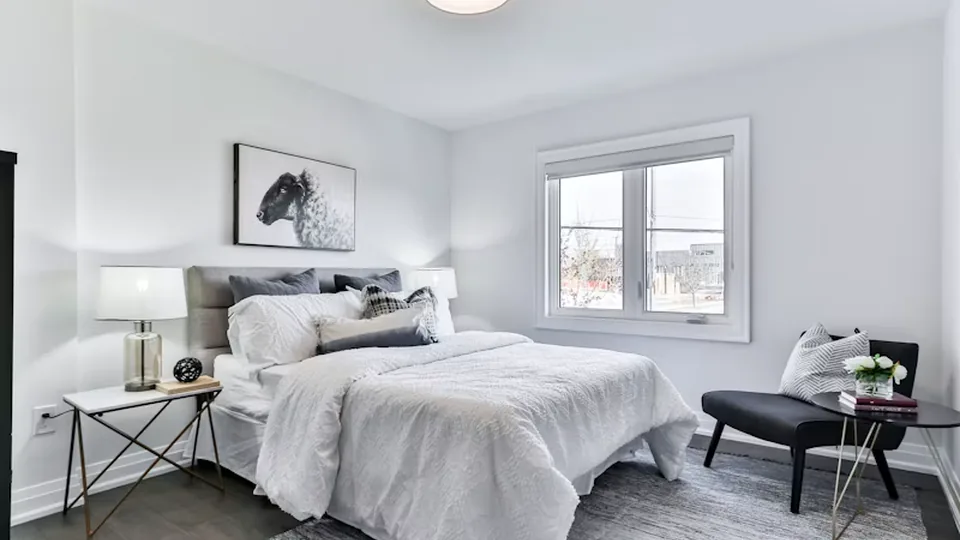 Finished bedroom with updated walls, trim, and flooring